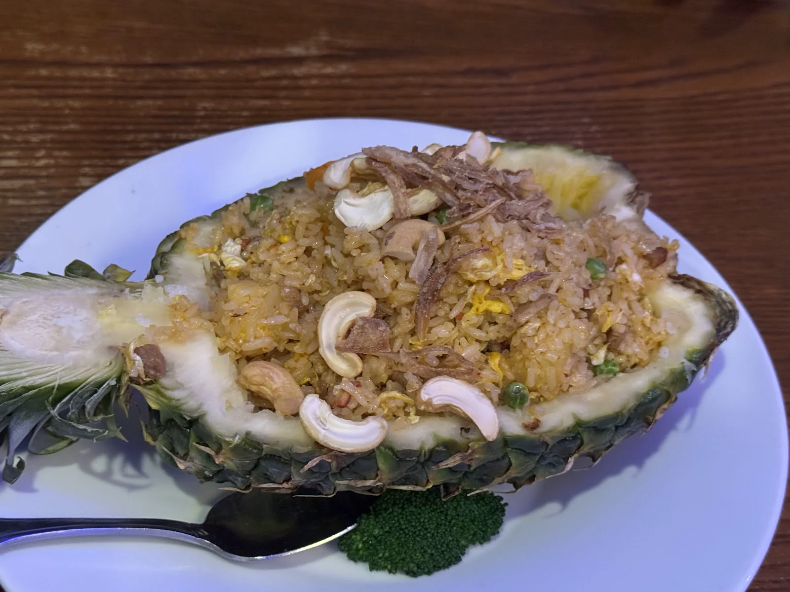Fried rice served in a hollowed pineapple with cashews
