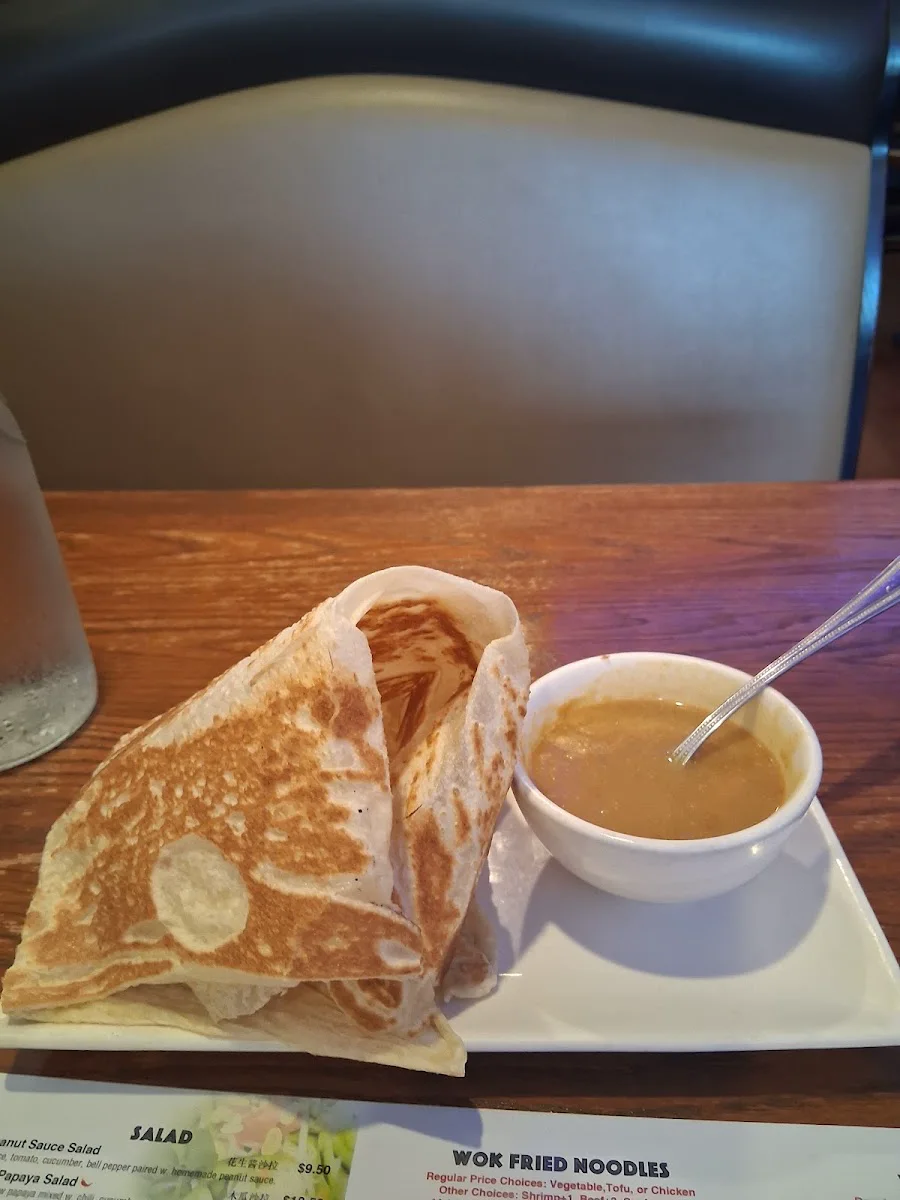 Roti canai flatbread with a bowl of curry sauce